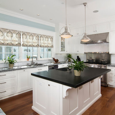 Kitchen - traditional kitchen idea in San Francisco with recessed-panel cabinets, stainless steel appliances, white cabinets, white backsplash and subway tile backsplash