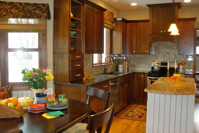Example of a mid-sized classic u-shaped light wood floor eat-in kitchen design in Chicago with an undermount sink, flat-panel cabinets, medium tone wood cabinets, granite countertops, beige backsplash, ceramic backsplash, stainless steel appliances and an island