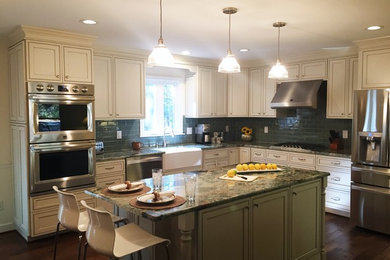 Example of a large classic l-shaped dark wood floor open concept kitchen design in Richmond with a farmhouse sink, beaded inset cabinets, white cabinets, granite countertops, green backsplash, glass tile backsplash, stainless steel appliances and an island