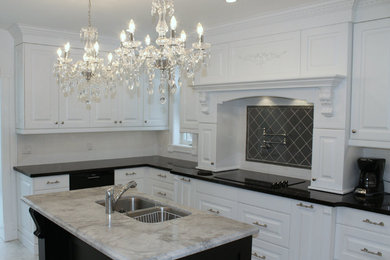 Example of a large classic u-shaped marble floor open concept kitchen design in Toronto with a double-bowl sink, recessed-panel cabinets, white cabinets, marble countertops, white backsplash, ceramic backsplash, black appliances and an island