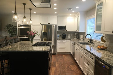 Example of a large classic l-shaped dark wood floor and brown floor eat-in kitchen design in San Francisco with recessed-panel cabinets, white cabinets, granite countertops, stainless steel appliances, an island and gray countertops