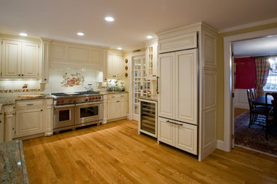 Inspiration for a mid-sized timeless l-shaped light wood floor kitchen pantry remodel in Boston with raised-panel cabinets, white cabinets, granite countertops, white backsplash, ceramic backsplash, paneled appliances, no island and an undermount sink