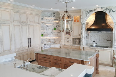 Elegant eat-in kitchen photo in Miami with a farmhouse sink, recessed-panel cabinets, white cabinets, marble countertops, white backsplash, marble backsplash, two islands and white countertops