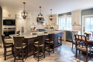Example of a large classic l-shaped eat-in kitchen design in Boston with a farmhouse sink, shaker cabinets, white cabinets, granite countertops, white backsplash, stone tile backsplash, stainless steel appliances and an island