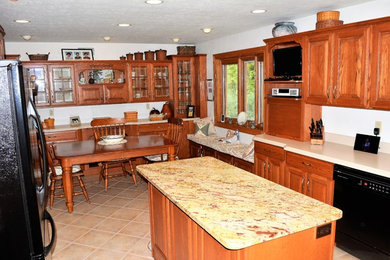Example of a classic ceramic tile eat-in kitchen design in Other with medium tone wood cabinets, stainless steel appliances and an island