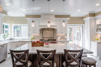 Eat-in kitchen - mid-sized traditional u-shaped porcelain tile and beige floor eat-in kitchen idea in San Francisco with an undermount sink, white cabinets, quartz countertops, glass tile backsplash, stainless steel appliances, an island, recessed-panel cabinets and gray backsplash