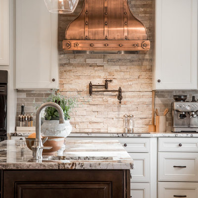 Kitchen - traditional kitchen idea in Tampa with beige backsplash and stone tile backsplash