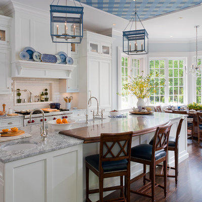 Inspiration for a timeless eat-in kitchen remodel in New York with a farmhouse sink, shaker cabinets, white cabinets, white backsplash, subway tile backsplash and paneled appliances