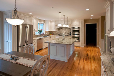 Inspiration for a large timeless u-shaped medium tone wood floor and brown floor eat-in kitchen remodel in Boston with an undermount sink, shaker cabinets, white cabinets, an island, marble countertops, multicolored backsplash, marble backsplash and stainless steel appliances