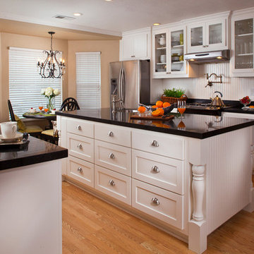 Traditional white kitchen with black tops