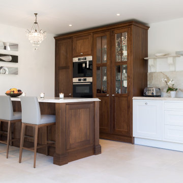 Traditional white kitchen with walnut island and pantry