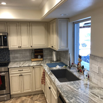 Traditional White Raised Panel Cabinets with Gray Countertops