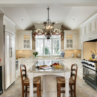 Inspiration for a timeless u-shaped limestone floor enclosed kitchen remodel in New York with an undermount sink, beaded inset cabinets, beige cabinets, granite countertops, beige backsplash, an island and paneled appliances