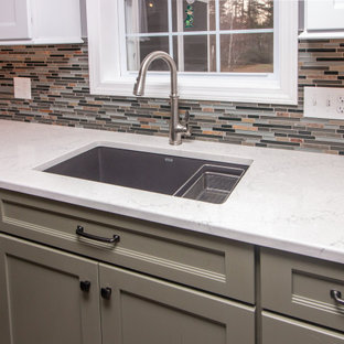 Large traditional eat-in kitchen appliance - Example of a large classic u-shaped vinyl floor and gray floor eat-in kitchen design in Boston with a single-bowl sink, shaker cabinets, white cabinets, quartz countertops, multicolored backsplash, glass sheet backsplash, stainless steel appliances, a peninsula and white countertops