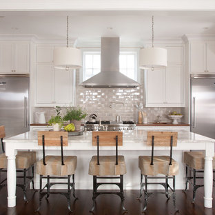 Design ideas for a traditional galley kitchen in Denver with stainless steel appliances, marble benchtops, recessed-panel cabinets, white cabinets and glass tile splashback.