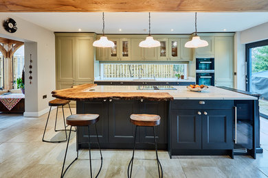 Design ideas for a medium sized classic single-wall open plan kitchen in Other with a built-in sink, shaker cabinets, green cabinets, quartz worktops, white splashback, window splashback, stainless steel appliances, porcelain flooring, an island, beige floors and white worktops.