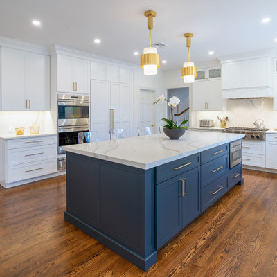 Kitchen - large transitional dark wood floor and brown floor kitchen idea in Philadelphia with an undermount sink, shaker cabinets, white cabinets, quartz countertops, white backsplash, quartz backsplash, stainless steel appliances, an island and white countertops
