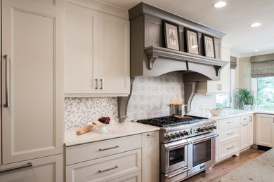 Example of a large transitional u-shaped eat-in kitchen design in St Louis with a farmhouse sink, shaker cabinets, quartz countertops, multicolored backsplash, stainless steel appliances, an island and stone tile backsplash