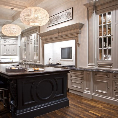 Large elegant l-shaped dark wood floor and brown floor eat-in kitchen photo in Glasgow with a farmhouse sink, recessed-panel cabinets, gray cabinets, marble countertops, white backsplash, marble backsplash, stainless steel appliances, an island and multicolored countertops