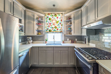Inspiration for a small transitional u-shaped ceramic tile enclosed kitchen remodel in New Orleans with an undermount sink, recessed-panel cabinets, gray cabinets, quartzite countertops, green backsplash, subway tile backsplash and stainless steel appliances