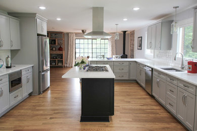 Example of a large transitional medium tone wood floor eat-in kitchen design in Charlotte with a double-bowl sink, shaker cabinets, gray cabinets, quartz countertops, white backsplash, ceramic backsplash, stainless steel appliances, an island and white countertops