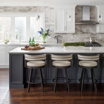 Inspiration for a large transitional l-shaped dark wood floor and brown floor kitchen remodel in Other with white cabinets, quartz countertops, gray backsplash, stainless steel appliances, an island, an undermount sink, shaker cabinets and stone tile backsplash