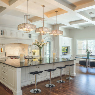 Huge transitional eat-in kitchen ideas - Inspiration for a huge transitional medium tone wood floor eat-in kitchen remodel in Dallas with an undermount sink, raised-panel cabinets, white cabinets, marble countertops, white backsplash, stainless steel appliances and an island