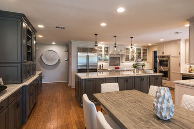 Large transitional l-shaped medium tone wood floor and brown floor eat-in kitchen photo in Phoenix with a farmhouse sink, shaker cabinets, gray cabinets, quartz countertops, white backsplash, subway tile backsplash, stainless steel appliances, an island and white countertops