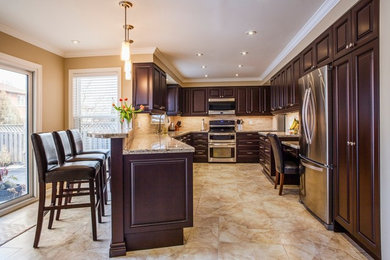 Example of a mid-sized transitional kitchen design in Toronto