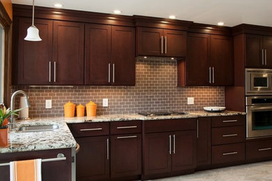 Transitional l-shaped ceramic tile and beige floor kitchen photo in Boston with a double-bowl sink, shaker cabinets, dark wood cabinets, granite countertops, beige backsplash, ceramic backsplash and stainless steel appliances