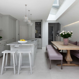 Inspiration for a large classic kitchen/diner in London with a single-bowl sink, marble worktops, white splashback, an island, white floors and grey worktops.