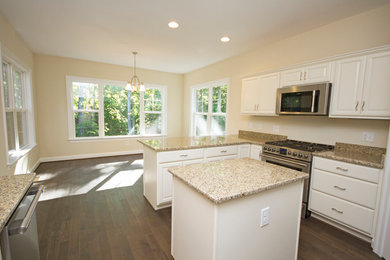 Inspiration for a large transitional u-shaped dark wood floor eat-in kitchen remodel in Richmond with a double-bowl sink, raised-panel cabinets, white cabinets, granite countertops, beige backsplash, stainless steel appliances and an island