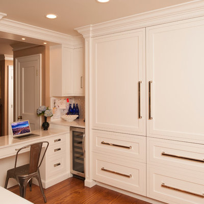 Example of a transitional l-shaped open concept kitchen design in New York with shaker cabinets, beige cabinets, solid surface countertops and stainless steel appliances