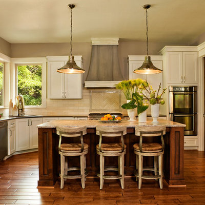 Example of a transitional kitchen design in Portland with stainless steel appliances, subway tile backsplash and quartz countertops
