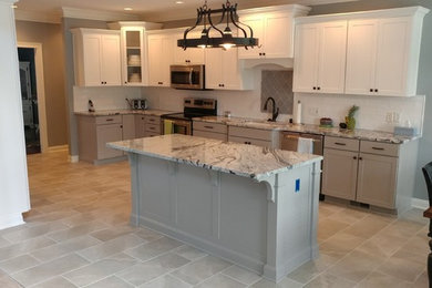 Inspiration for a large transitional l-shaped gray floor and ceramic tile eat-in kitchen remodel in Louisville with an undermount sink, shaker cabinets, gray cabinets, white backsplash, stainless steel appliances, an island, marble countertops and subway tile backsplash