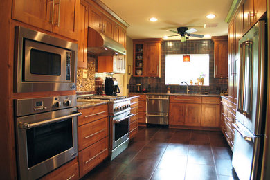 Example of a large transitional u-shaped eat-in kitchen design in New Orleans with a double-bowl sink, medium tone wood cabinets, marble countertops, brown backsplash, ceramic backsplash, stainless steel appliances and no island
