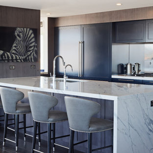 Inspiration for a large transitional galley open plan kitchen in Sydney with an undermount sink, shaker cabinets, mirror splashback, with island, grey benchtop, blue cabinets, marble benchtops, stainless steel appliances, dark hardwood floors and black floor.