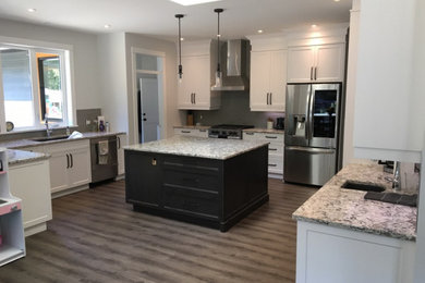 Eat-in kitchen - large transitional u-shaped eat-in kitchen idea in Other with shaker cabinets, white cabinets, quartz countertops, gray backsplash, stainless steel appliances, an island and multicolored countertops