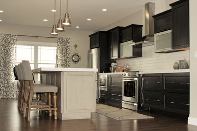 Example of a large transitional galley dark wood floor eat-in kitchen design in Chicago with quartzite countertops, white backsplash, brick backsplash, stainless steel appliances and an island
