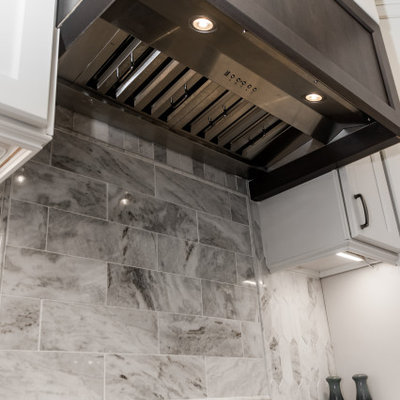 Large transitional u-shaped eat-in kitchen photo in Columbus with shaker cabinets, granite countertops, marble backsplash and an island