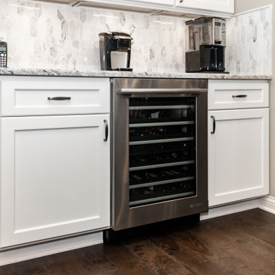 Large transitional u-shaped eat-in kitchen photo in Columbus with shaker cabinets, granite countertops, marble backsplash and an island