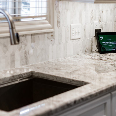 Large transitional u-shaped eat-in kitchen photo in Columbus with shaker cabinets, granite countertops, marble backsplash and an island