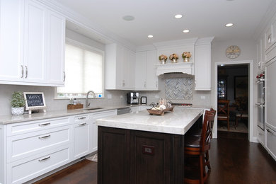 Inspiration for a large transitional u-shaped dark wood floor and brown floor enclosed kitchen remodel in Chicago with a single-bowl sink, shaker cabinets, white cabinets, quartz countertops, gray backsplash, subway tile backsplash, paneled appliances and an island