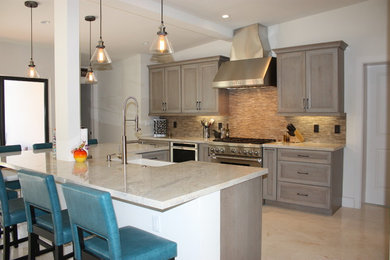 Large transitional l-shaped open concept kitchen photo in Miami with a farmhouse sink, recessed-panel cabinets, gray cabinets, quartz countertops, multicolored backsplash, porcelain backsplash, stainless steel appliances and an island