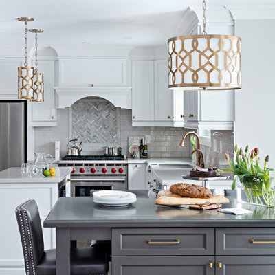 Example of a large transitional l-shaped dark wood floor and brown floor open concept kitchen design in Toronto with stainless steel appliances, white cabinets, granite countertops, gray backsplash, glass tile backsplash, shaker cabinets, two islands and an undermount sink