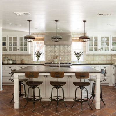Transitional u-shaped kitchen photo in Dallas with recessed-panel cabinets, white cabinets, beige backsplash and stainless steel appliances