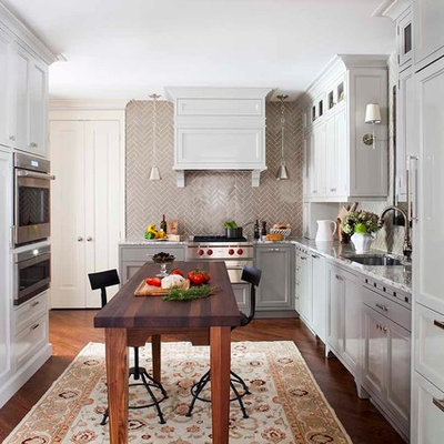 Inspiration for a transitional l-shaped enclosed kitchen remodel in Atlanta with an undermount sink, recessed-panel cabinets, gray cabinets, granite countertops, beige backsplash, subway tile backsplash and paneled appliances