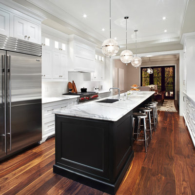 Inspiration for a transitional galley eat-in kitchen remodel in Toronto with an undermount sink, recessed-panel cabinets, white cabinets, marble countertops, white backsplash and stainless steel appliances