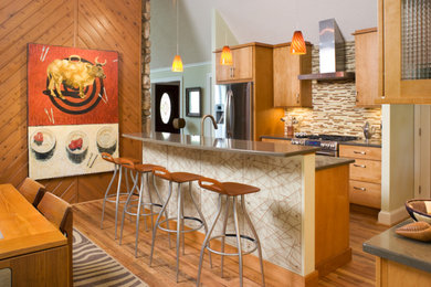 Eat-in kitchen - large transitional galley medium tone wood floor and brown floor eat-in kitchen idea in Other with flat-panel cabinets, light wood cabinets, multicolored backsplash, matchstick tile backsplash, stainless steel appliances and an island