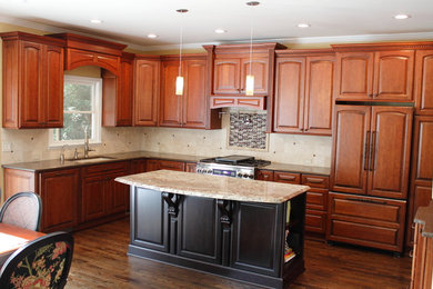 Inspiration for a mid-sized timeless l-shaped dark wood floor eat-in kitchen remodel in Atlanta with an undermount sink, raised-panel cabinets, medium tone wood cabinets, quartz countertops, beige backsplash, porcelain backsplash, stainless steel appliances and an island